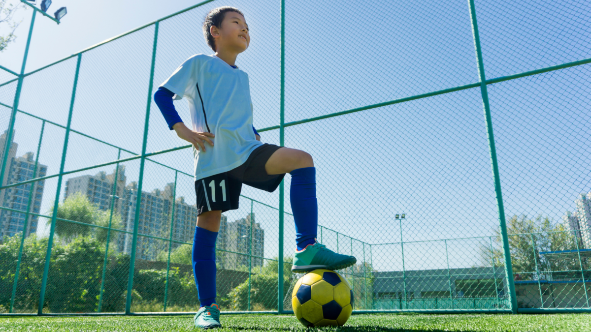 STUDENT ATHLETE WITH A SOCCER BALL, preventing sports injuries