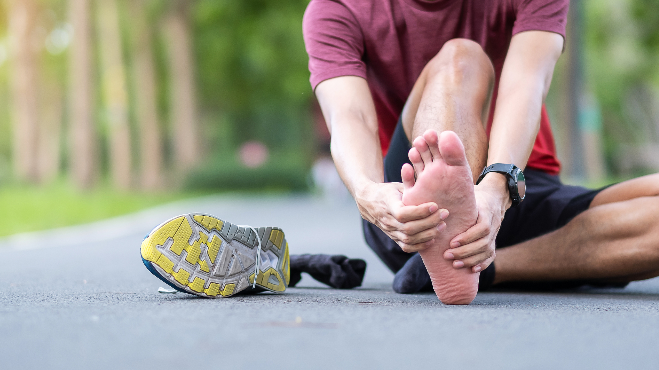 image shows foot pain, person grabbing onto foot