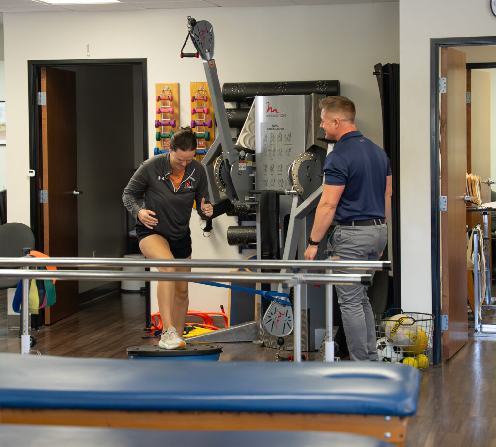Physical therapist treating patients in clinic